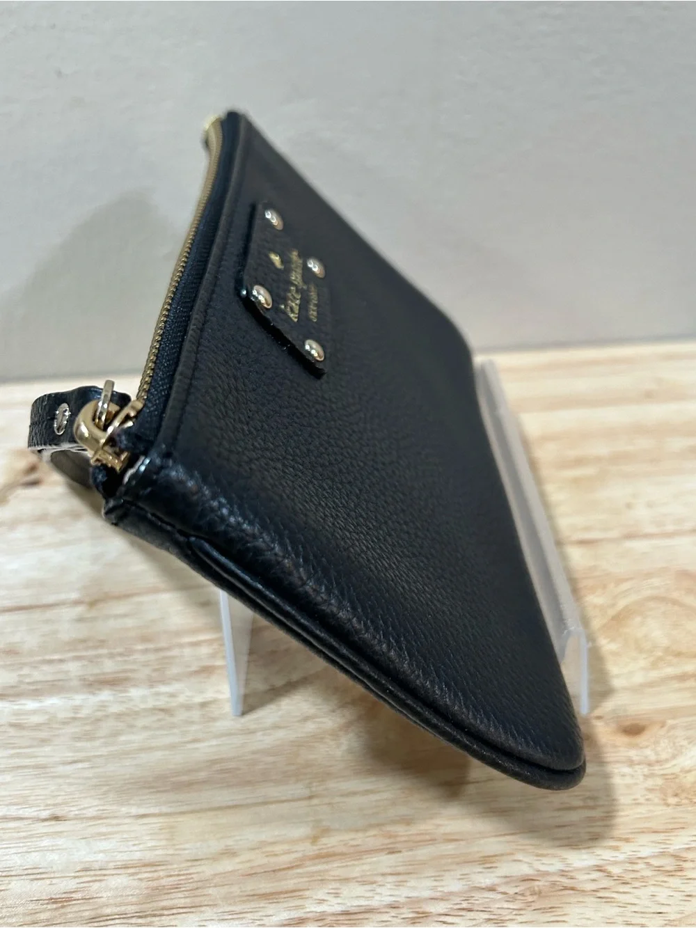 kate spade black pebbled leather wristlet with gold-tone logo